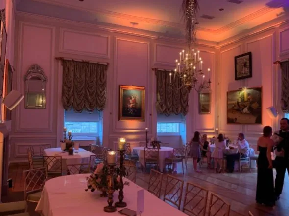 Wireless uplighters washing a wedding venue in warm light
