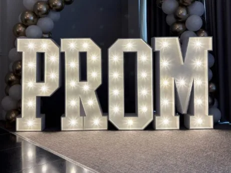 White light up letters spelling PROM