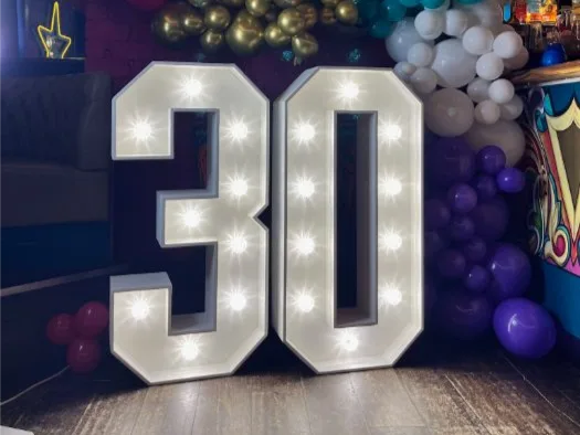 White light up number 30 with navy balloons